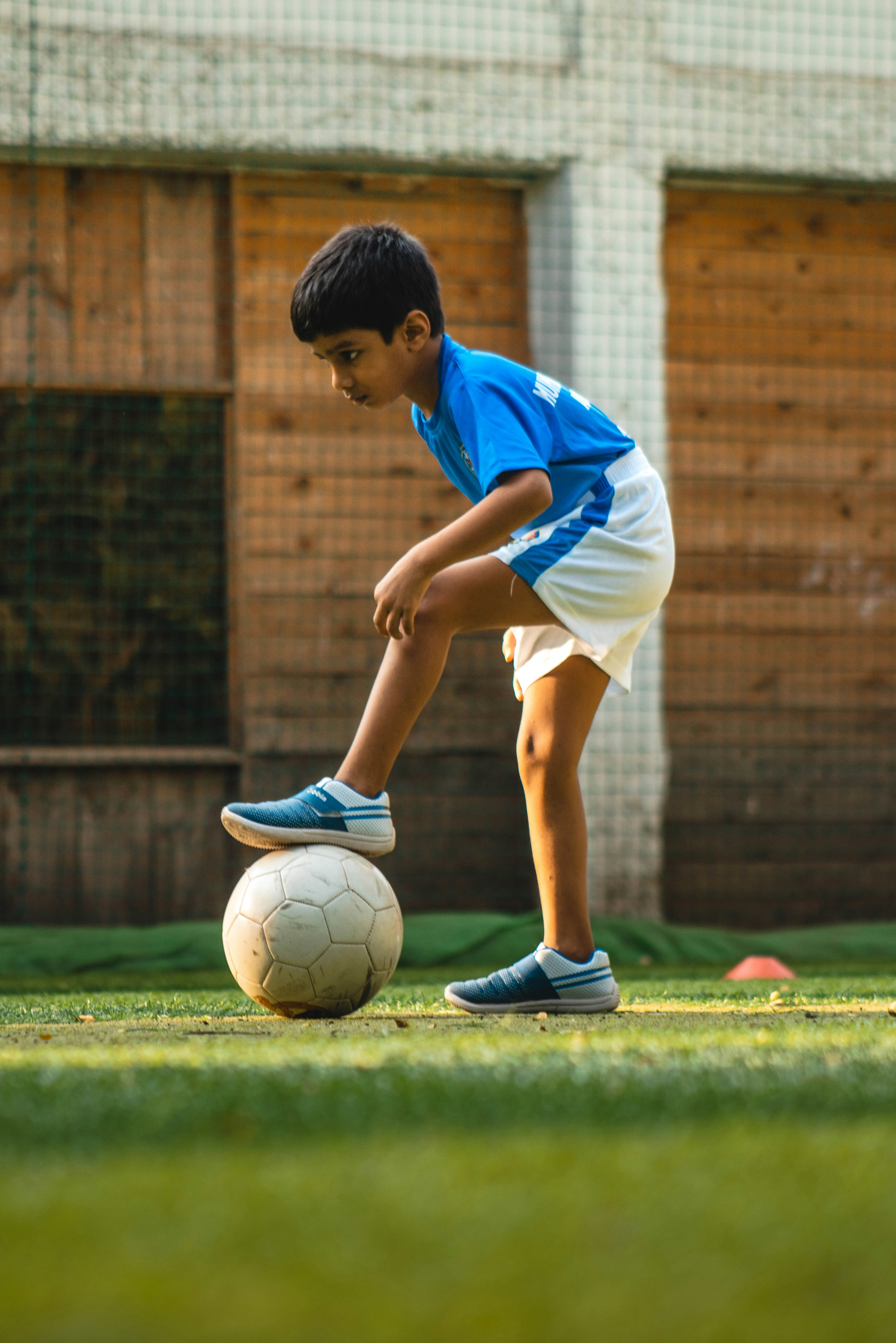 Child practicing soccer